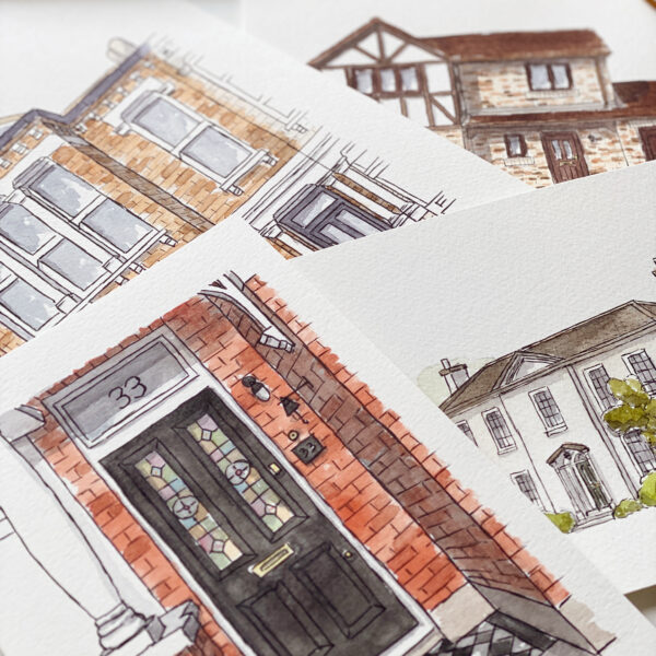 Kerri Awosile watercolour house and door illustrations laying flat on a table with a paint palette next to them