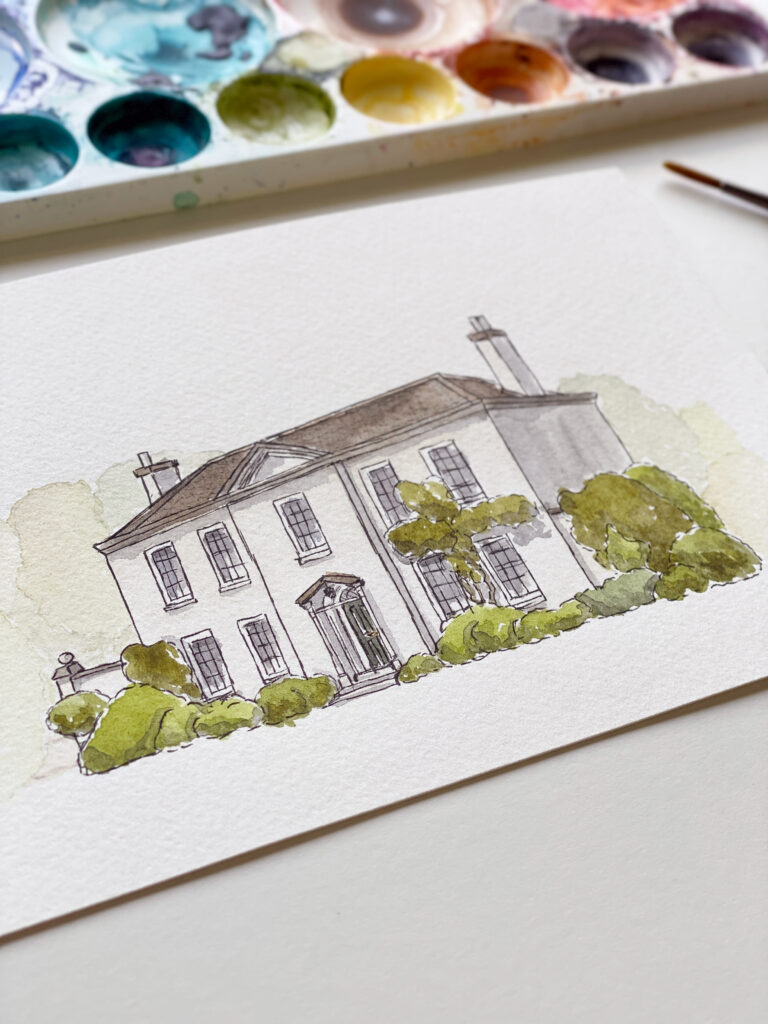 Kerri Awosile watercolour mansion house illustration laying flat on a table with a paint palette next to it